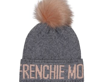 May include: Gray knit beanie with a pink faux fur pom pom and the text "FRENCHIE MO" in pink lettering.