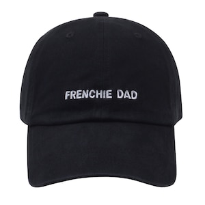 May include: A black baseball cap with white embroidered text that reads "FRENCHIE DAD".