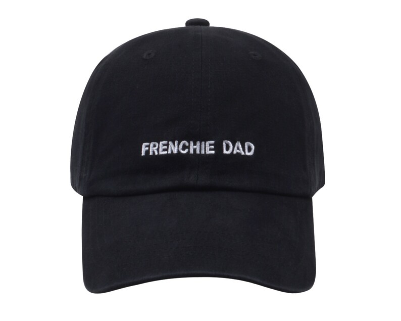 May include: A black baseball cap with white embroidered text that reads "FRENCHIE DAD".