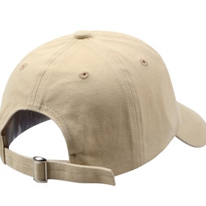 May include: A beige baseball cap with a curved brim and an adjustable strap. The cap has a classic design and is made of a soft, comfortable fabric.