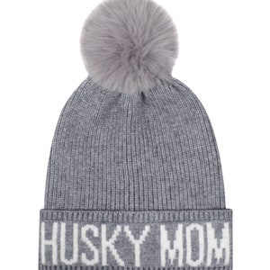May include: Gray knitted beanie with a white pom pom and the text "HUSKY MOM" in white lettering.