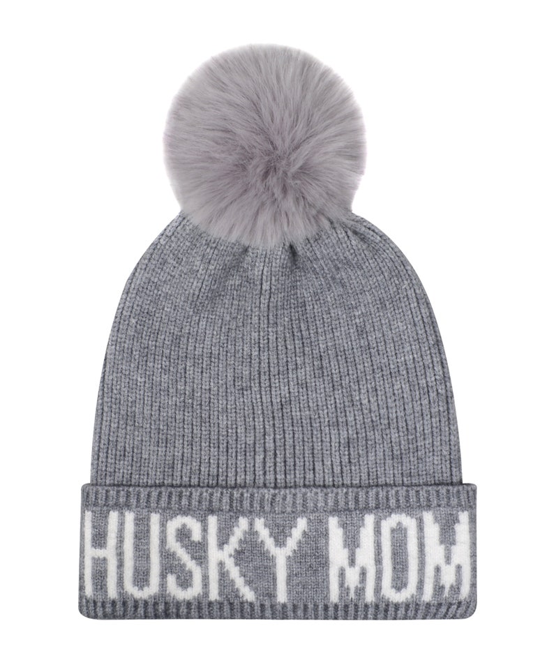 May include: Gray knitted beanie with a white pom pom and the text "HUSKY MOM" in white lettering.