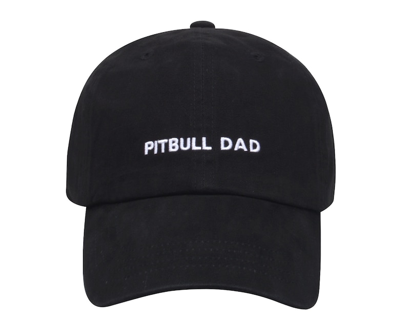 May include: Black baseball cap with white embroidered text that reads "PITBULL DAD".