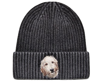 May include: A black knit beanie with a brown and white dog embroidered on the front.