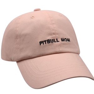 May include: A pink baseball cap with black embroidery that reads "PITBULL MOM".