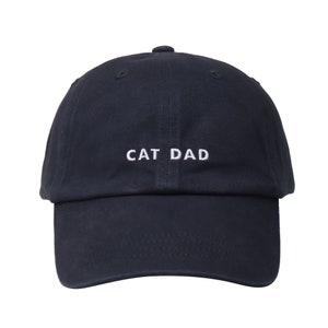 May include: A navy blue baseball cap with white embroidered text that reads "CAT DAD".