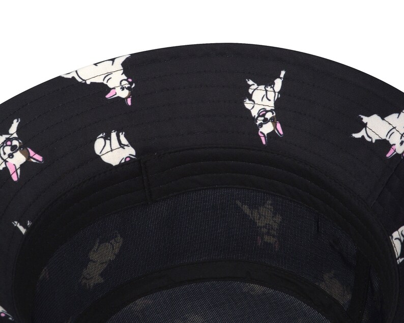 May include: Black bucket hat with a white and black French bulldog print. The hat has a mesh lining.