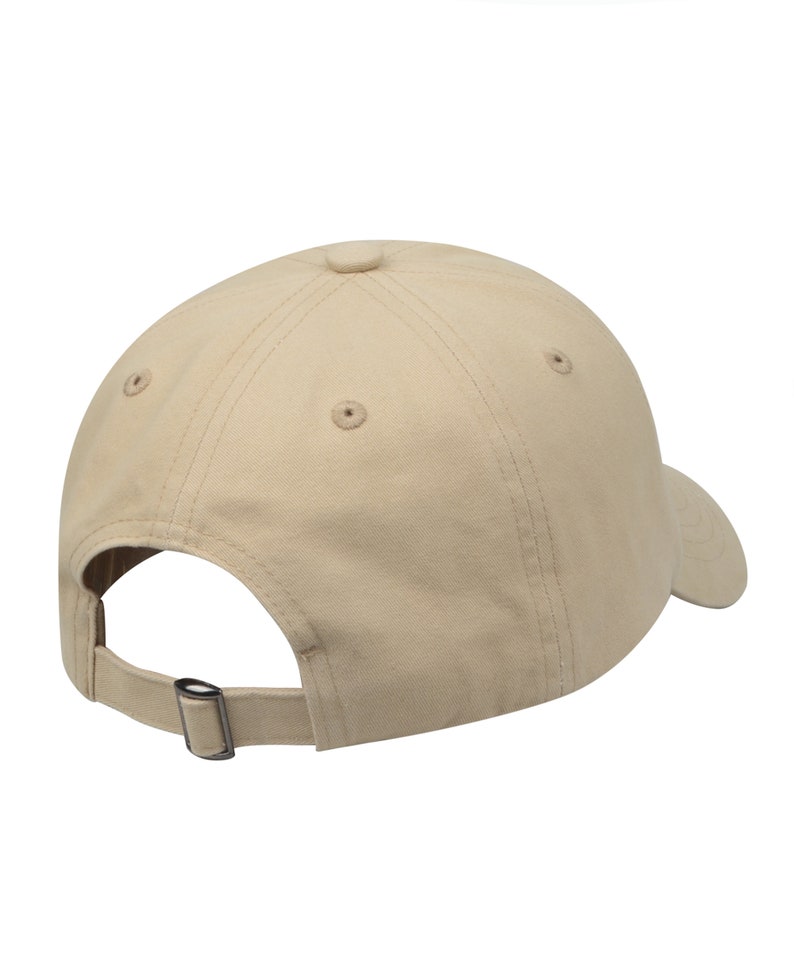 May include: A beige baseball cap with a curved brim and an adjustable strap. The cap is made of a soft, cotton fabric.