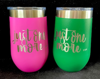 May include: Two stainless steel wine tumblers with the text "Just one more..." in silver lettering. One tumbler is pink and the other is green.