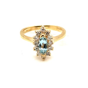 Anillo de oro amarillo de 14 quilates con topacio azul y diamantes