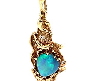 May include: A gold pendant with a green opal and small diamonds set in a textured, organic design.