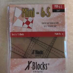 May include: A plastic package containing a quilting tool called "Mini - 6.5" for making 3 1/2 inch X-Blocks. The tool is made of clear plastic and has a grid pattern. The package also includes the text "X-Blocks" and "Quilt Queen Designs".