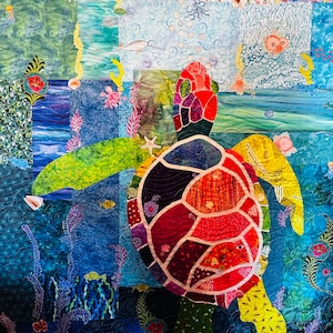 May include: A colorful patchwork quilt depicting a sea turtle swimming in a blue ocean with coral reefs and other sea life. The turtle is made of many different fabrics, creating a mosaic effect.