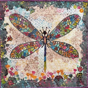 May include: A colorful mosaic dragonfly with intricate details, set against a background of floral patterns and a light beige texture. The dragonfly's wings are a mix of vibrant colors, including blue, green, red, and yellow. The background features delicate floral designs in shades of pink, purple, and brown. The image is framed with a dark purple border.