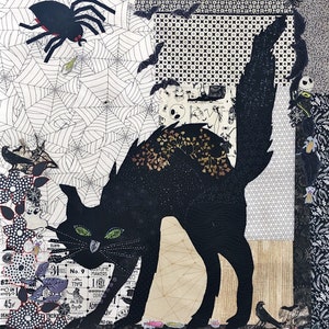 May include: A black cat with green eyes is silhouetted against a background of black and white patterned fabric. The cat is walking towards the left side of the image. There are several small black and white images of bats, spiders, and ghosts in the background.