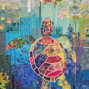 May include: A colorful patchwork quilt featuring a large, multi-colored sea turtle with a floral design. The turtle is surrounded by a blue and green background with floral patterns and geometric shapes.