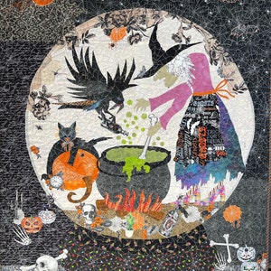May include: A black and white Halloween quilt with a witch stirring a cauldron, a black cat, and a raven. The quilt is decorated with skulls, bats, and other Halloween imagery.