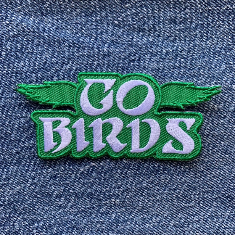 May include: Green and white embroidered patch with the words "GO BIRDS" and a stylized bird wing design.