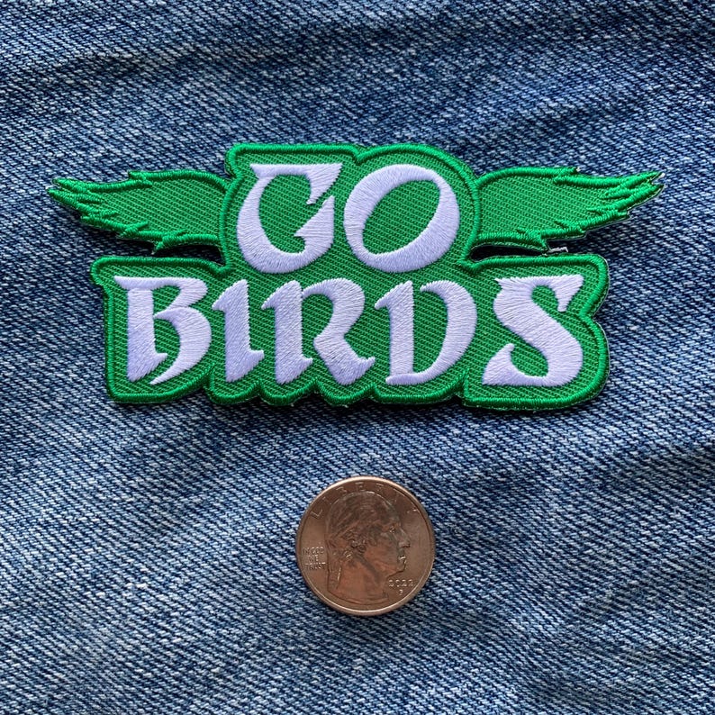 May include: Green and white embroidered patch with the words "GO BIRDS" and a stylized bird wing design.