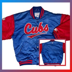 May include: A blue and red satin Chicago Cubs baseball jacket. The jacket features the word "Cubs" in red script across the chest. The sleeves are red, and the jacket has a snap-button closure. The Starter logo is visible on the sleeve.