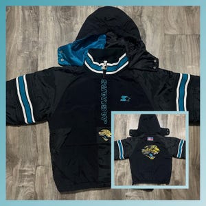 May include: Black and teal Starter jacket with the Jacksonville Jaguars logo and "Jaguars" text on the front. The jacket has a zipper closure, a hood, and a white stripe on the sleeve.