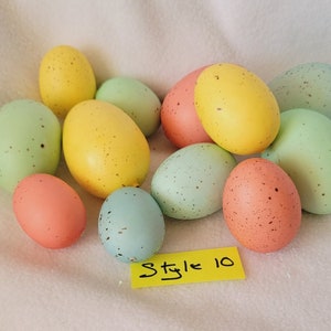May include: A collection of 12 speckled Easter eggs in various pastel colors, including yellow, green, blue, and pink. The eggs are arranged in a cluster on a white surface. The text "Style 10" is written on a yellow sticky note.