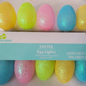 May include: A string of 10 Easter egg lights with a timer function. The lights are 3 feet long and come with 2 AA batteries. The eggs are yellow, green, pink, and blue with glitter.