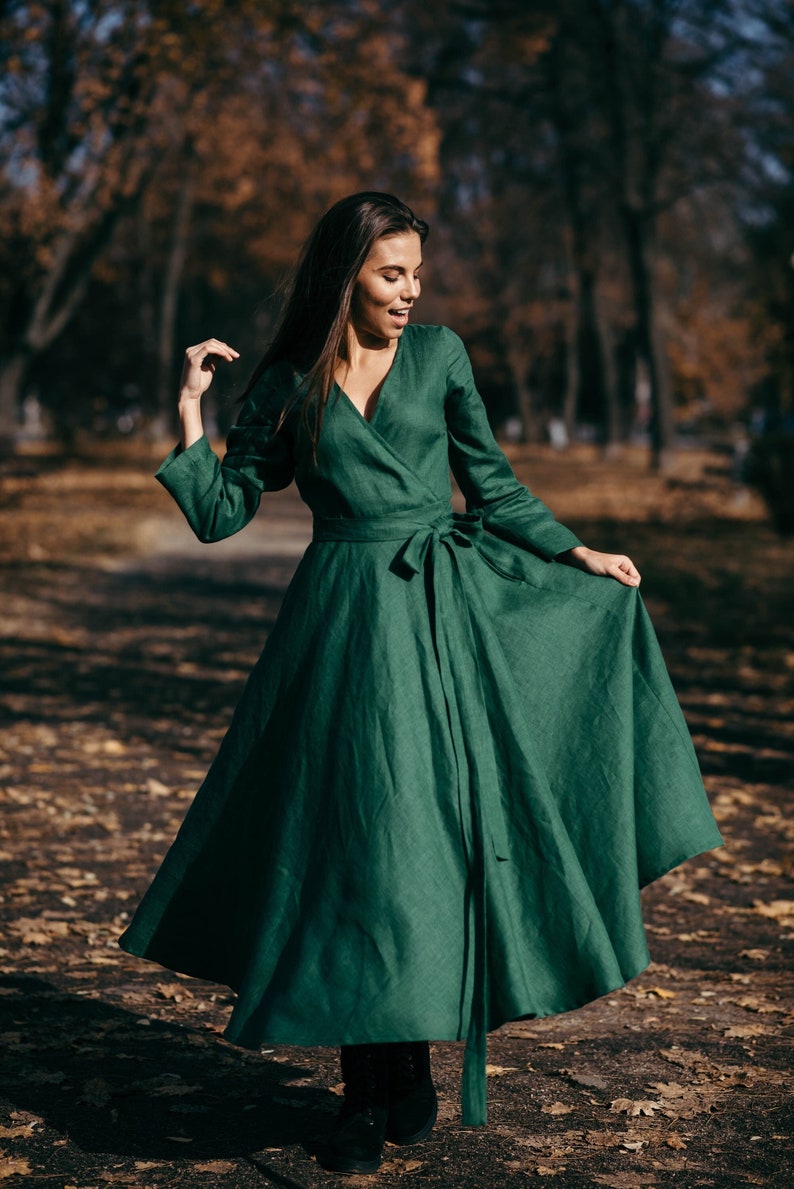 Green linen wrap dress in autumn forest, warm tones