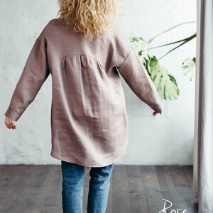 Back view of the rose taupe natural linen shirt with long sleeves, showcasing its immaculate construction, clean lines, and stylish design.