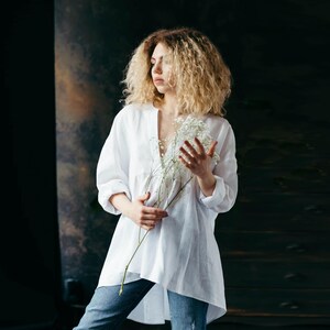 Side profile of the white oversized linen shirt, displaying the subtle structure and flattering shape.