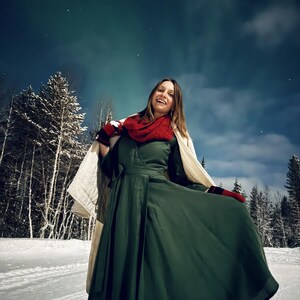 Navy linen wrap dress, winter outdoor setting with the Aurora lights in the sky