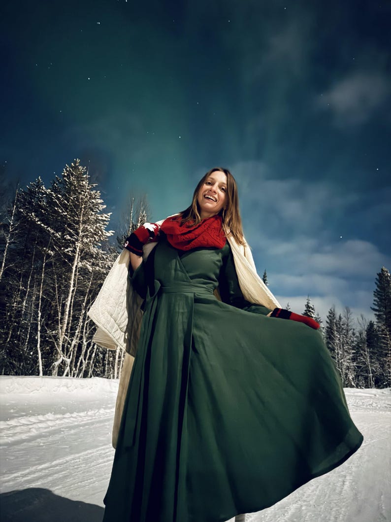 Navy linen wrap dress, winter outdoor setting with the Aurora lights in the sky