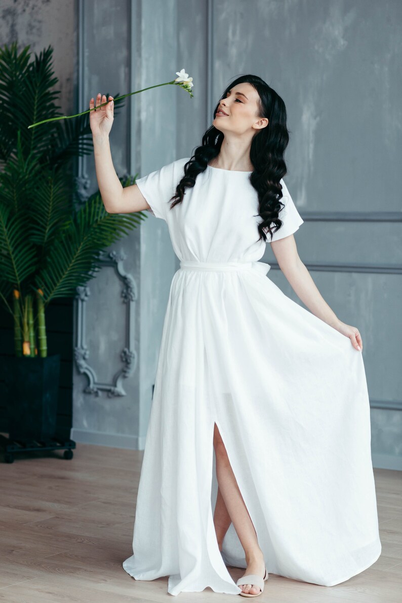 Linen wedding dress with pockets, twirling shot showing front slit