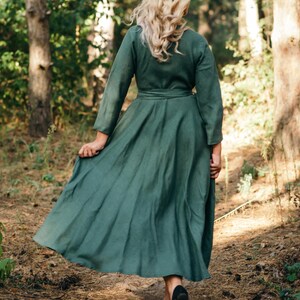 Green linen wrap dress, full length in woodland setting