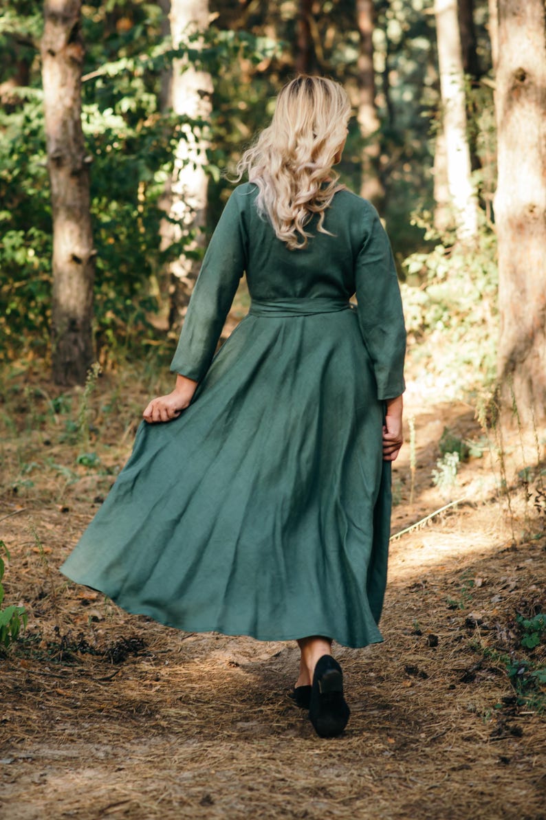Green linen wrap dress, full length in woodland setting