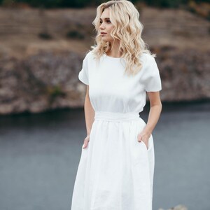 Close-up of linen wedding dress waist tie and bow detail
