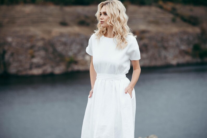 Close-up of linen wedding dress waist tie and bow detail