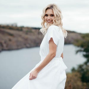 Boho wedding dress worn outdoors, model with tousled hair