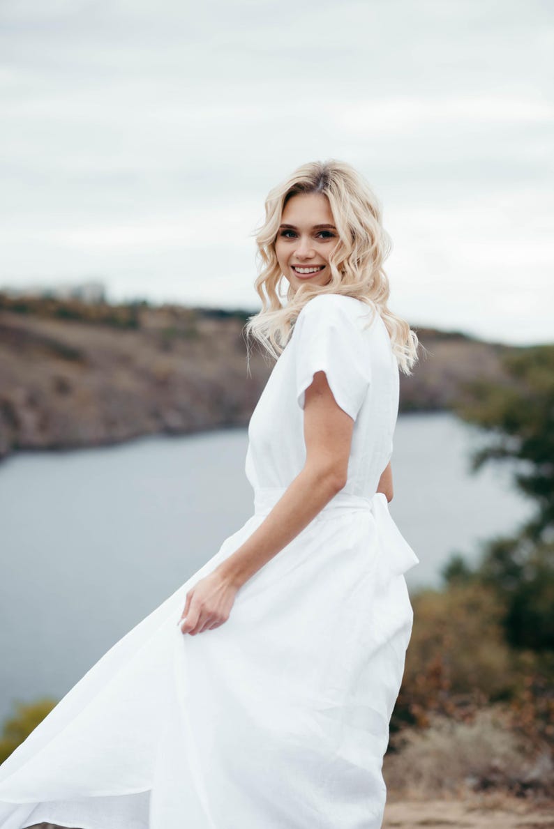 Boho wedding dress worn outdoors, model with tousled hair