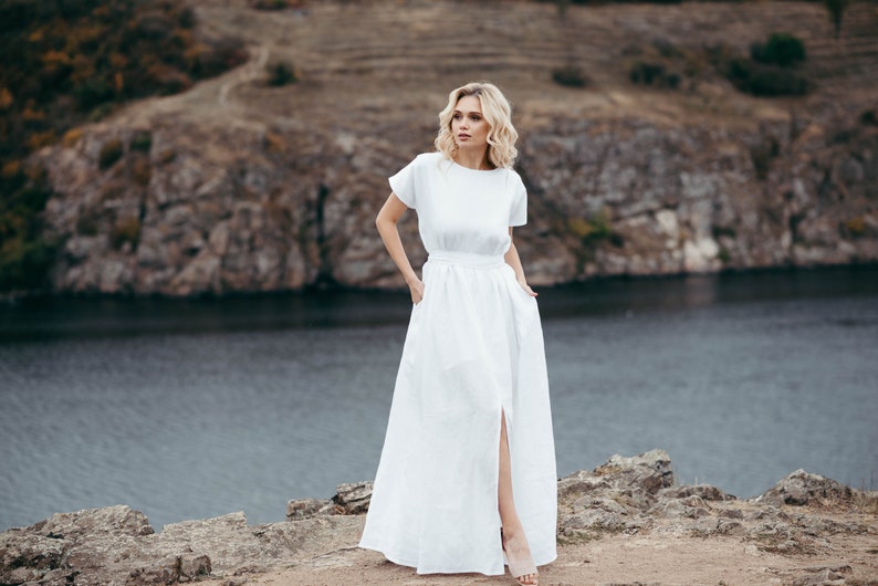 Linen wedding dress, full length by coastal rocks