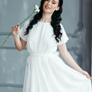 Boho wedding dress worn outdoors, model with tousled hair