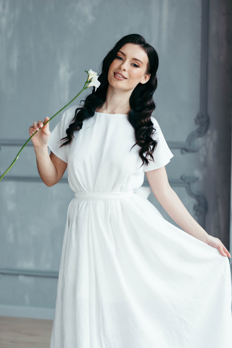 Boho wedding dress worn outdoors, model with tousled hair