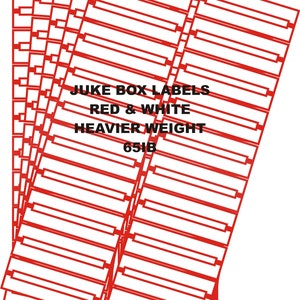 May include: A stack of rectangular paper sheets featuring a red border and a central white area for text. The sheets are printed with the text JUKE BOX LABELS RED & WHITE HEAVIER WEIGHT 65LB. The design consists of multiple rows of blank labels.