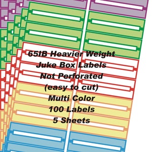 May include: A stack of five sheets of multi-colored jukebox labels in purple, green, red, yellow, and blue. The text reads: 65IB Heavier Weight Juke Box Labels Not Perforated (easy to cut) Multi Color 100 Labels 5 Sheets. Each label has a white center.