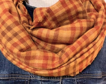 Rust, Orange, Brown, Camel make this 100 % cotton flannel scarf a beautiful and soft addition to attire sizes for everyone on your list