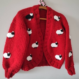 İconic sweater with sheeps and one black Sheep on the front