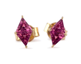 May include: A pair of gold earrings with pink gemstone studs. The gemstones are cut in a square shape with pointed corners.