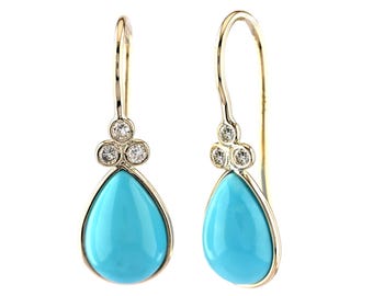 May include: A pair of gold-toned drop earrings with a teardrop-shaped, turquoise-colored stone. Each earring features three small, round, clear gemstones above the turquoise stone. The earrings have a simple hook design.