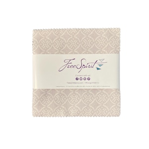 May include: A stack of fabric squares in a light beige color with a repeating geometric pattern. The fabric squares are wrapped with a white band featuring the "FreeSpirit" logo and social media information.