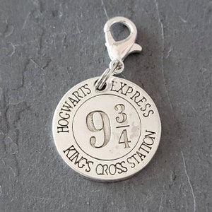 May include: Silver charm with a Hogwarts Express charm featuring the number 9 3/4 and the words "Hogwarts Express Kings Cross Station".